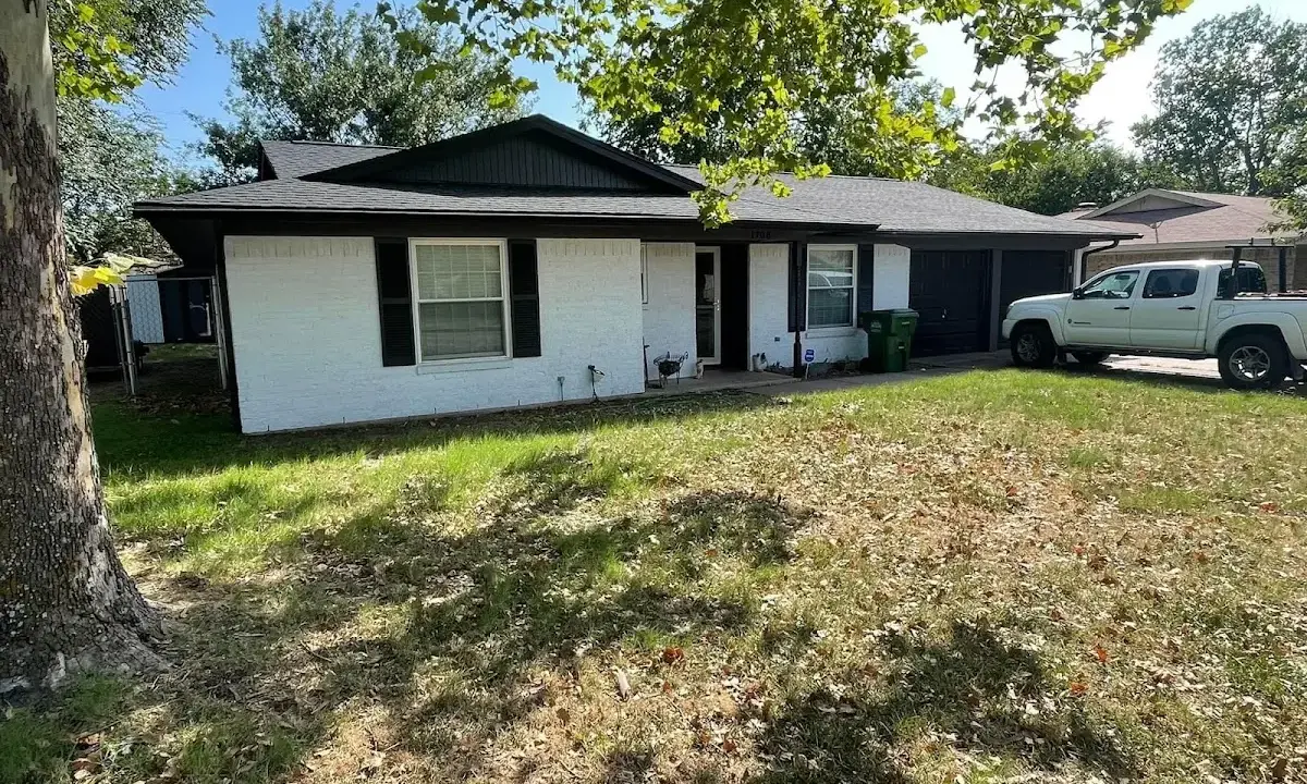 Professional roofing crew working on a residential roof in Heeia